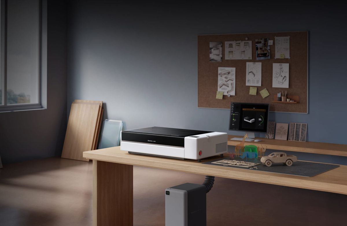 Bambu Lab R1 CO2 laser cutter on a workshop bench, shown in an official product photograph