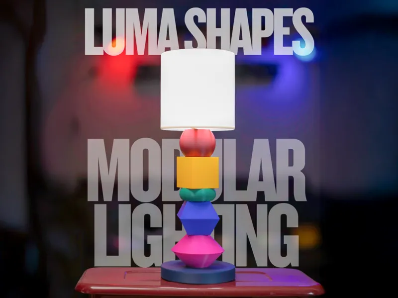 A lit LumaShapes lamp built from colourful stacked shapes